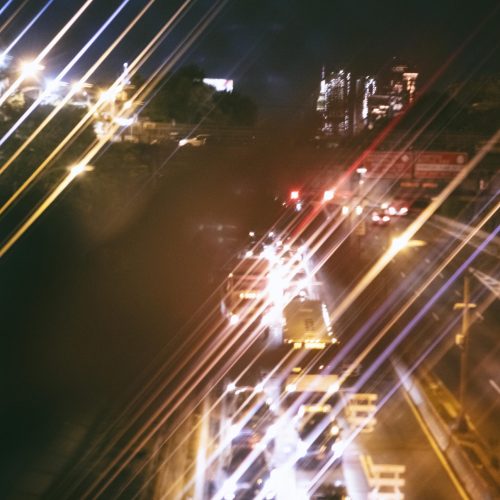 view-of-busy-city-highway-at-night-scaled